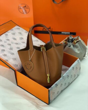 H Picotin Lock 18 bag in a brown or honey-colored shade.