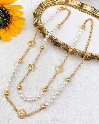 CC long necklace with pearls and gold-toned chain.