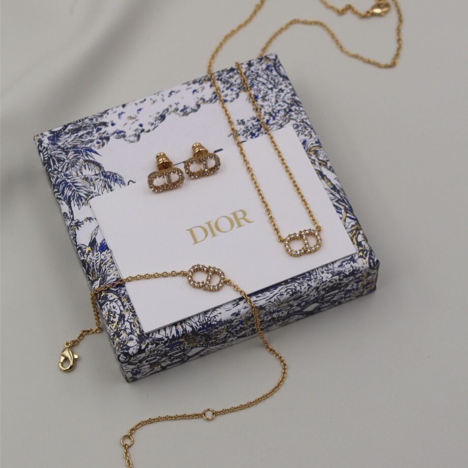CD Set in Clair D Collection| adorned with white crystals and crafted in gold-finish metal.