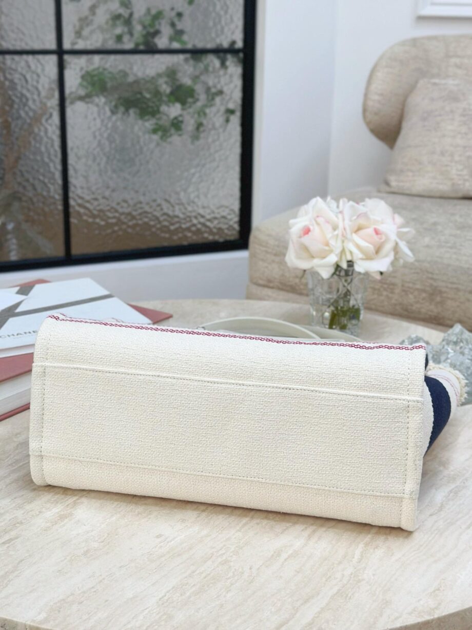 CC Deauville Tote Bag in a combination of beige/off-white and navy blue, with red stripes as an accent.