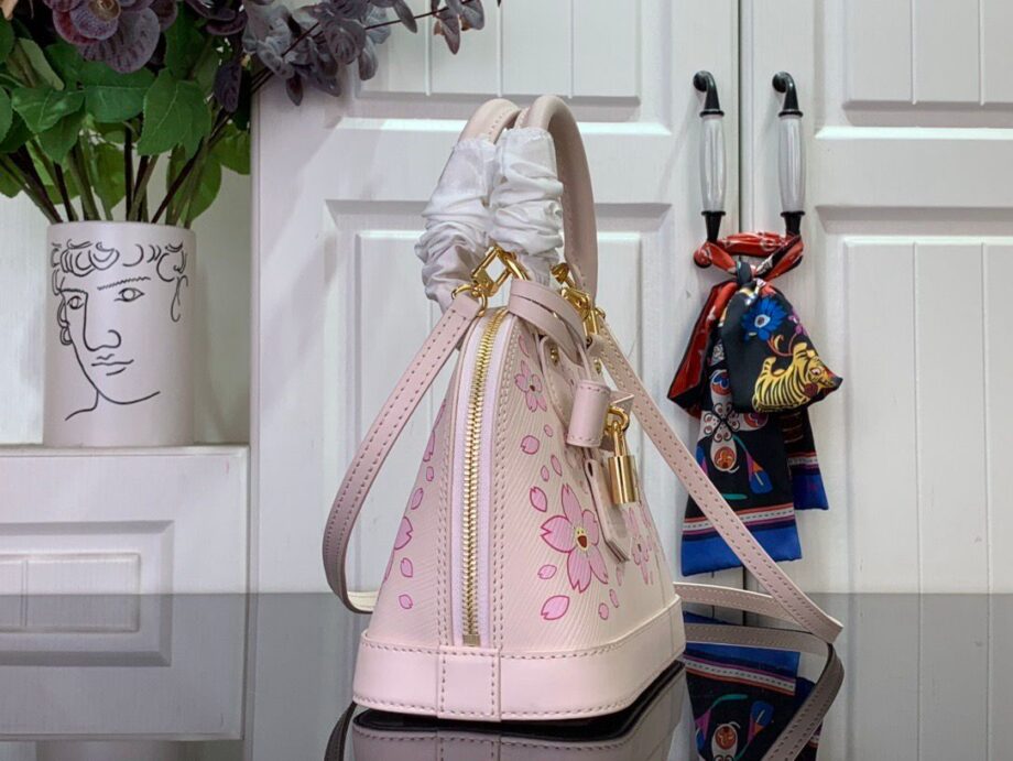 Loiu Alma BB bag in a light pink color, pink cherry blossom motifs.